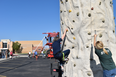 Hillary heads up the rock wall