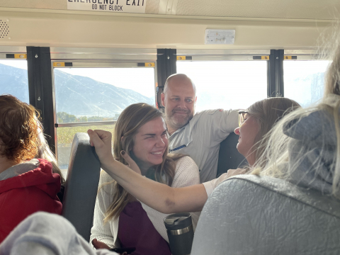 Teachers enjoy the field trip bus ride