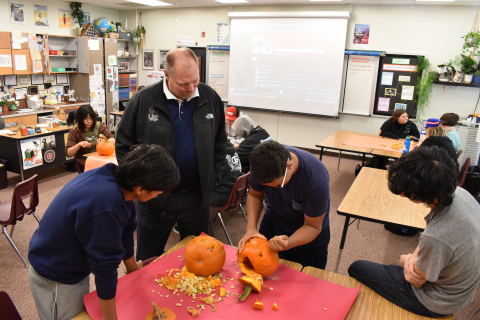 Students carve pumpkins