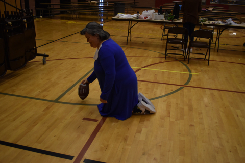 Sue will hold the football while you kick it!