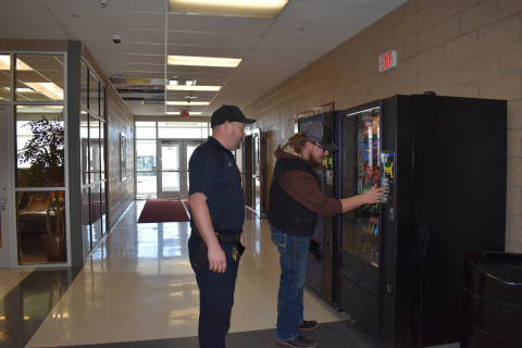 Hopes and Officer Smith free the chips from the Vending machine